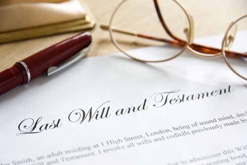 A Last Will and Testament lays on a table. A judge may require an Administrator or Executor be bonded before handling a deceased person's estate.